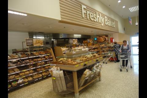 The bakery department uses natural wood and graphics to highlight the offer